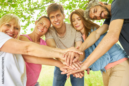 Group of friends stacks hands for motivation