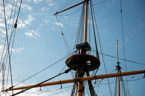 Masts, yards and rigging of sailing ship against blue sky