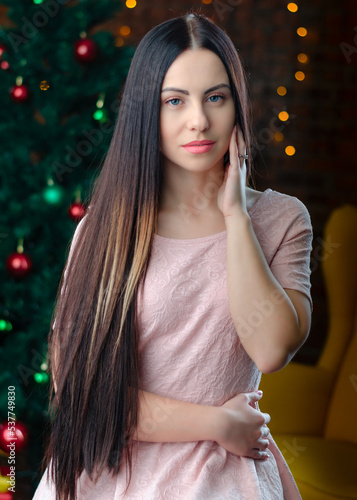 Wallpaper Mural Portreit of beautiful woman near the christmas tree lights background. Healthy long hair style. happy new year and Christmas concept.  Torontodigital.ca