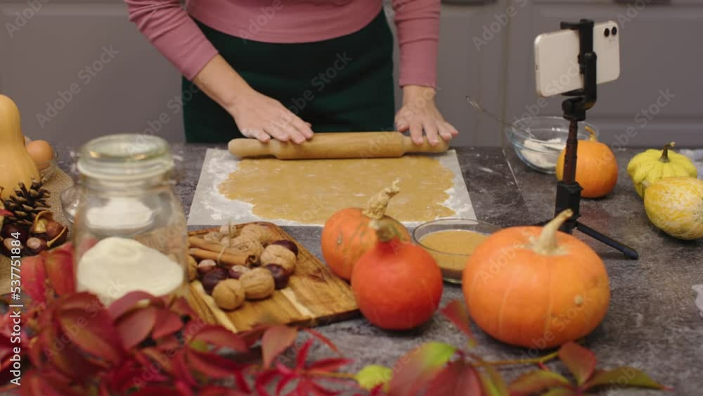 woman hands rolling out raw dough with rolling pin cooking pumpkin pie or pumpkin sweets for happy thanksgiving holiday traditional family dinner. happy autumn seasonal celebrations grateful thankful woman hands rolling out raw dough with rolling pin cooking pumpkin pie or pumpkin sweets for happy thanksgiving holiday traditional family dinner. happy autumn seasonal celebrations grateful thankful
