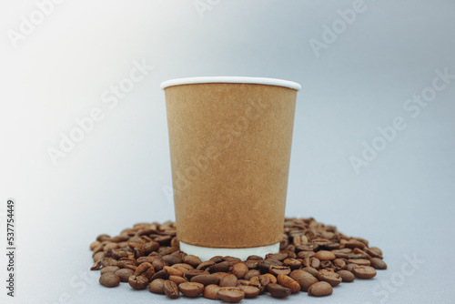 Mockup image of a paper cup with a lid on a clean gray background. 