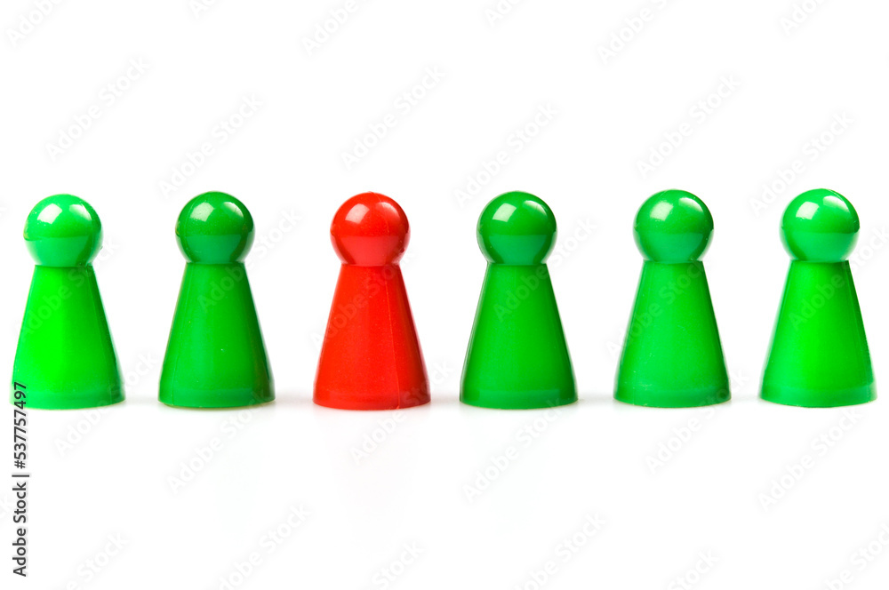 green plastic counters, one red. Leadership concept green plastic counters, one red. Leadership concept