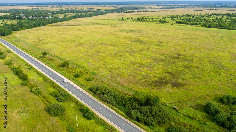 Top view of a road on a flat terrain on a summer day Top view of a road on a flat terrain on a summer day