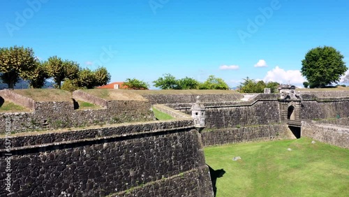 Drone View Rising From Behind Fortress Wall Revealing Old Village. photo