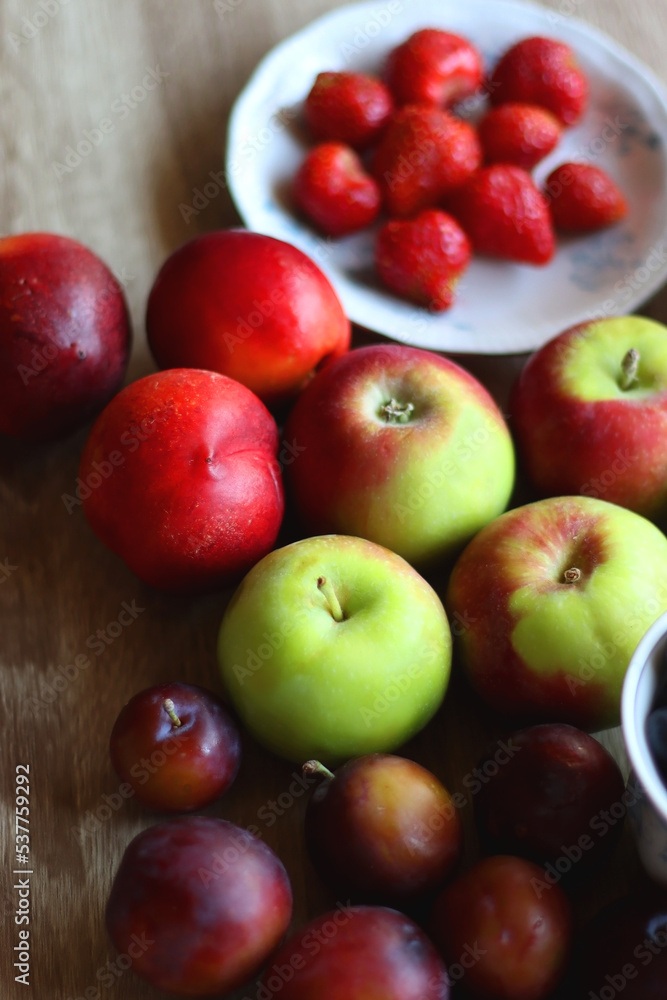 Various healthy seasonal food arranged on wooden background. Selective focus. Various healthy seasonal food arranged on wooden background. Selective focus.