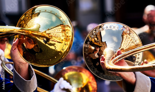 Reflection of half-timbered facades on the horns of the golden wind instruments