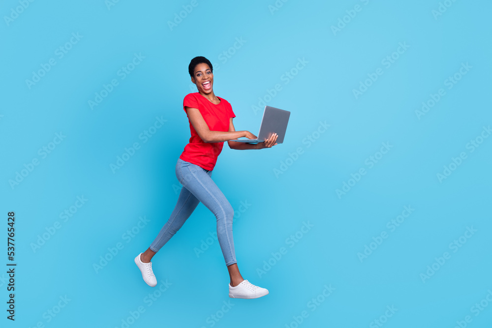 Photo of positive cute short hair person dressed red t-shirt walking jumping working modern gadget isolated blue color background Photo of positive cute short hair person dressed red t-shirt walking jumping working modern gadget isolated blue color background