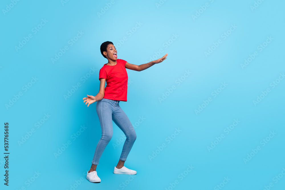 Full size portrait of positive satisfied person enjoy free time clubbing isolated on blue color background