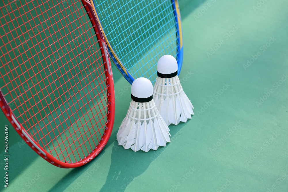 Cream white badminton shuttlecock and racket on floor in indoor badminton  court, copy space, soft and selective focus on shuttlecocks. Stock Photo |  Adobe Stock