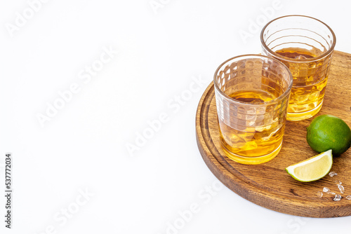 Glass of strong alcoholic drink whiskey with ice. Alcohol background