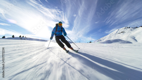 professional skier skiing on slopes in the Swiss alps towards the camera photo