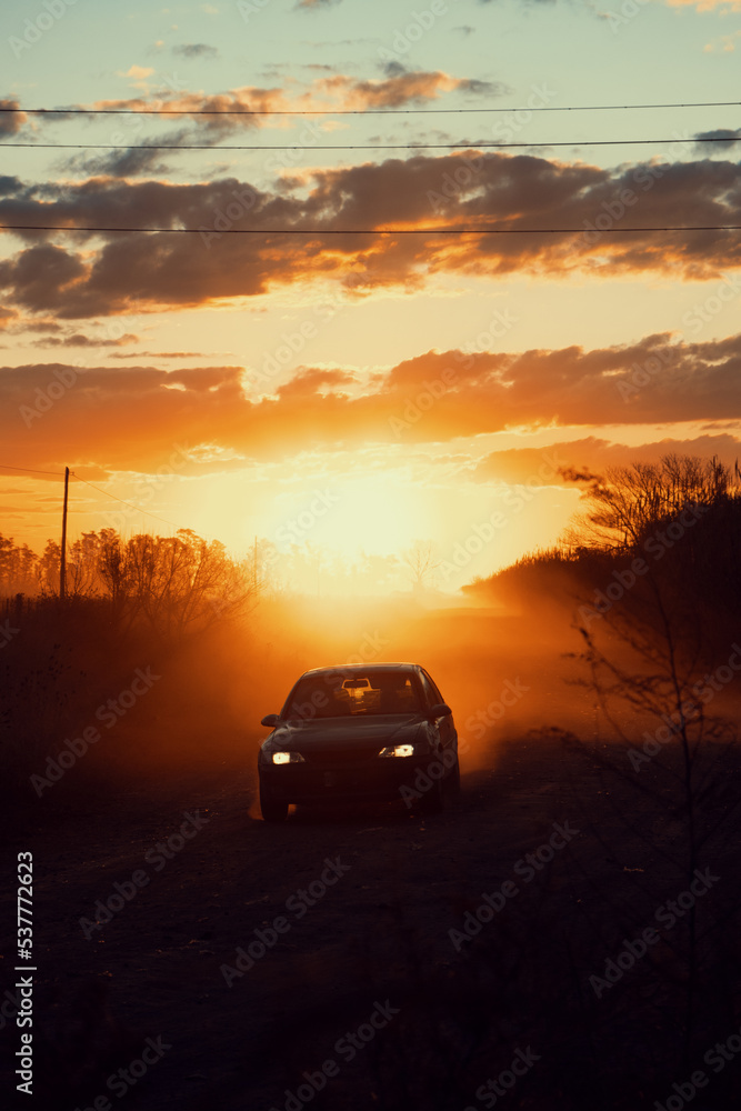 Car moving fast in a road during sunset