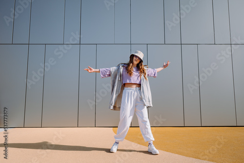 Woman dancerfront of wall. Breakdancing, street dancing, hiphop, freestyle dance.