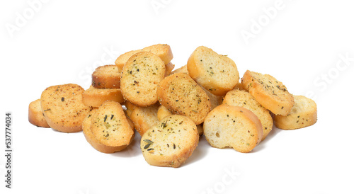 A pile of round bread croutons with spices on a white isolated background. Snack