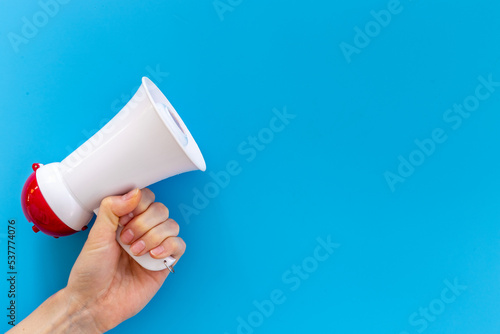 Attention concept. Hand holding megaphone for announcing hot news or advertising