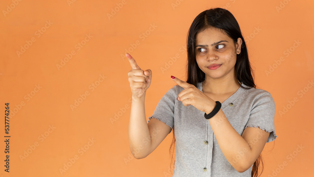 Portrait of attractive cheerful girl demonstrating copy empty space, isolated over color background pointing Portrait of attractive cheerful girl demonstrating copy empty space, isolated over color background pointing