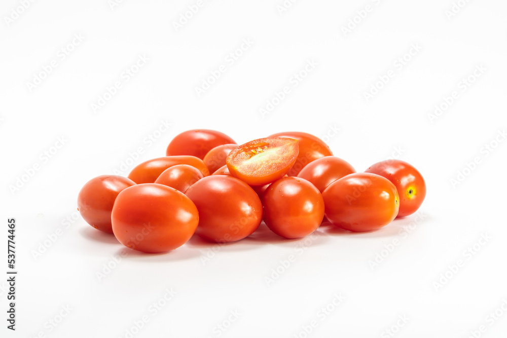 red cherry tomato stack isolated on white background. small tomato support healthy vision and help protect against cancer. red cherry tomato stack isolated on white background. small tomato support healthy vision and help protect against cancer.