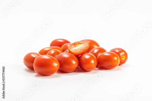 red cherry tomato stack isolated on white background.  small tomato support healthy vision and help protect against cancer.