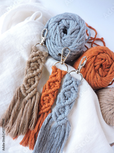 Macrame keychain made of cotton thread. Handcrafted work. Decoration Artworks. Handicrafts. Macrame art for gift. Keychain isolated on a white background. Handmade. 