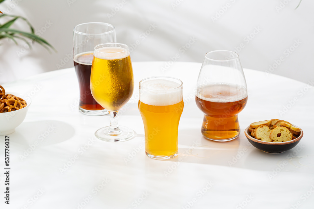 Several glasses of dark light beer craft on light surface copy space Several glasses of dark light beer craft on light surface copy space
