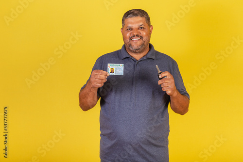 Brazilian black male, adult with driver's license, Brazilian document, and car key.