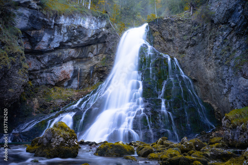 Beautiful fall waterfall with mirrored water
