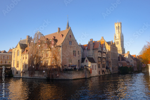 Rozenhoedkaai in Brugge , panoramic view along the canal and medieval buildings in old town during  winter sunny day : Brugge , Belgium : November 30 , 2019 photo