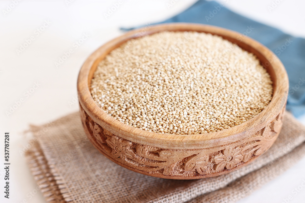 Top view image of quinoa in wooden plate on table Top view image of quinoa in wooden plate on table