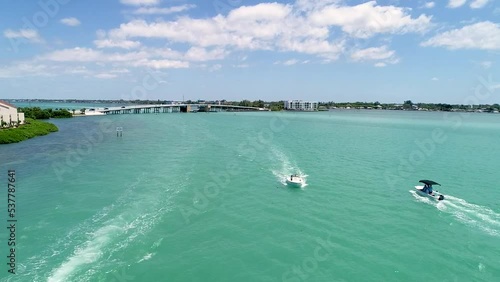 Drone view of calm water sparkling under blue sky, boats sailing in Lemon Bay Englewood, Florida photo