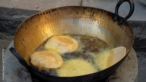 Making of delicious Bengali Luchi (deep fried bread). This is another version of Indian Poori. Indian village vegetarian poodi photo