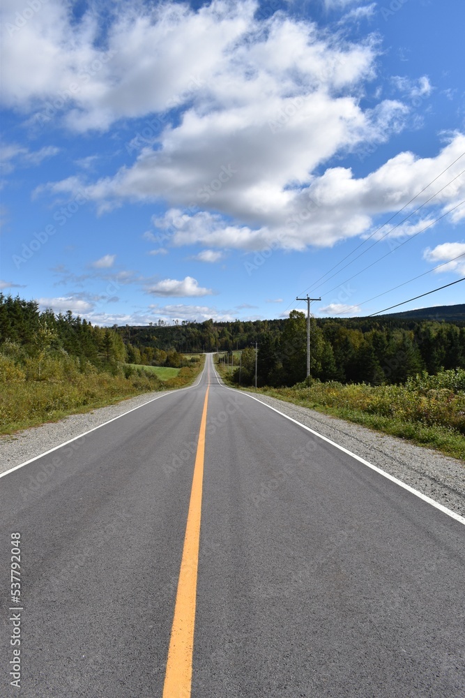 A country road under blue skies, Québec, Canada