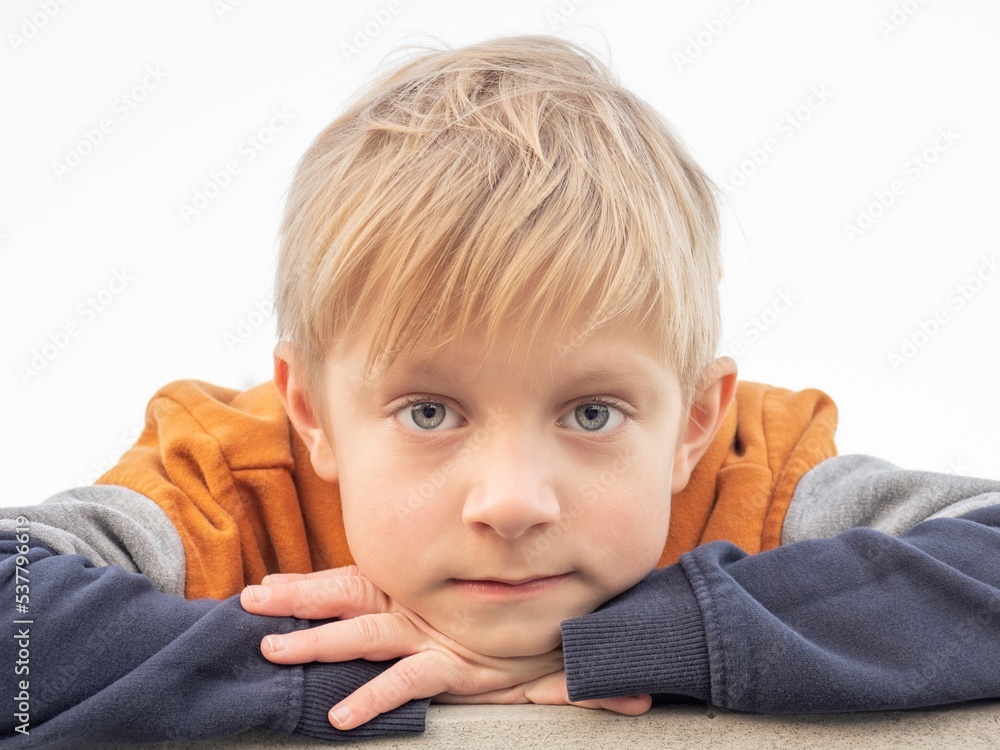 Portrait of a blue-eyed blonde caucasian boy looking at the camera Portrait of a blue-eyed blonde caucasian boy looking at the camera