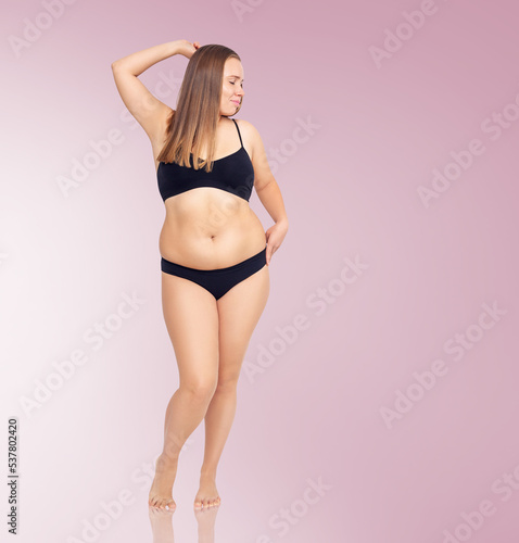 Confident woman with overweight natural body posing.