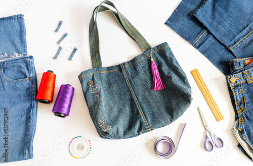 Denim bag with sewing accessories. top view, crafting with denim , recycling concept