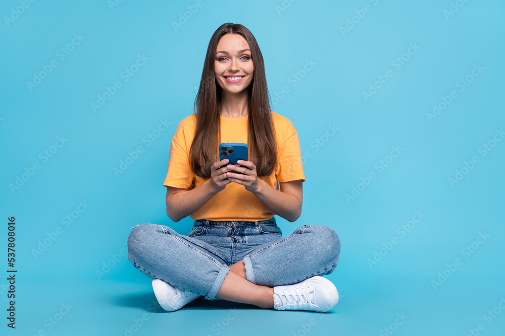 Photo of funny cute girl dressed yellow t-shirt chatting instagram twitter facebook telegram empty space isolated blue color background Photo of funny cute girl dressed yellow t-shirt chatting instagram twitter facebook telegram empty space isolated blue color background