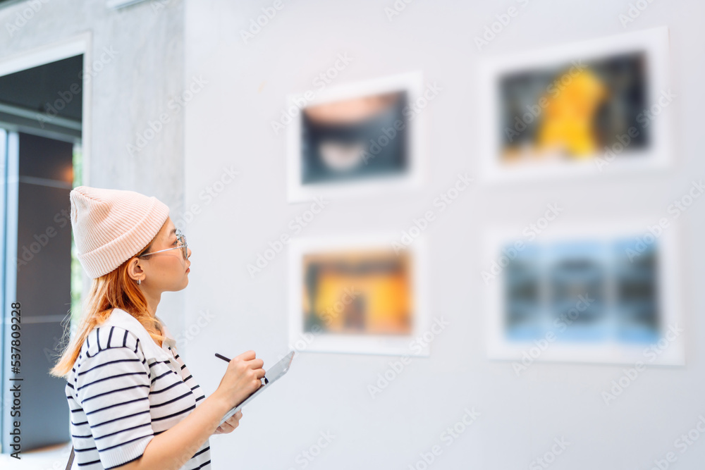 Woman visiting art gallery her looking pictures on wall watching photo frame painting at artwork museum people lifestyle concept. Woman visiting art gallery her looking pictures on wall watching photo frame painting at artwork museum people lifestyle concept.
