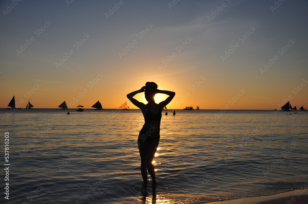 silhouette of a woman on the beach