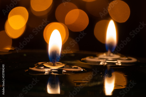 close up of two aromatherapy candles on oil with beautiful bokeh background of lights
