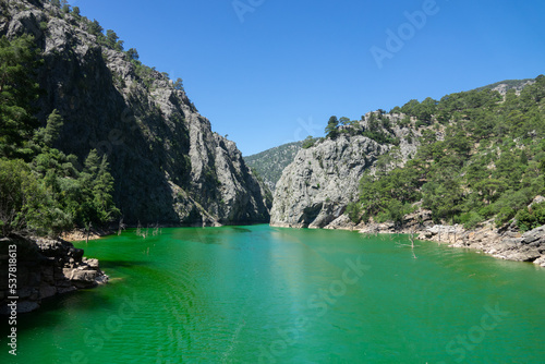 View of the lake with green water and on the mountain cliffs of the Green Canyon. Landscape of Green canyon, Manavgat, Antalya, Turkey