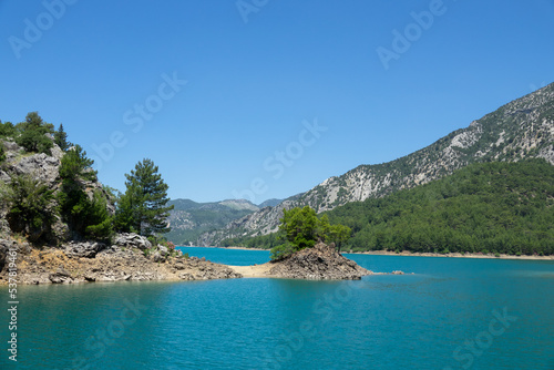 View of the lake with clear turquoise water and on the mountain cliffs of the Green Canyon. Landscape of Green canyon, Manavgat, Antalya, Turkey © Goldream