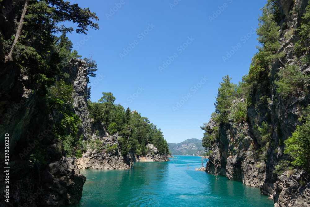 View of the lake with clear turquoise water and on the mountain cliffs of the Green Canyon. Landscape of Green canyon, Manavgat, Antalya, Turkey