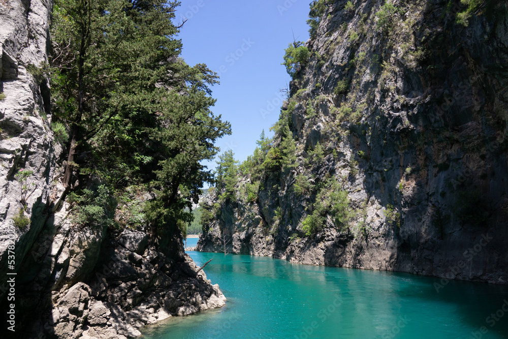 View of the lake with clear turquoise water and on the mountain cliffs of the Green Canyon. Landscape of Green canyon, Manavgat, Antalya, Turkey