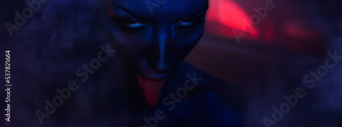 Halloween Horror night: goddess of destruction Kali. Female eyes and mouth with bloody tongue.