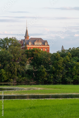 View of brick building with steeple from across the river in Fergus Falls, Minnesota USA. 