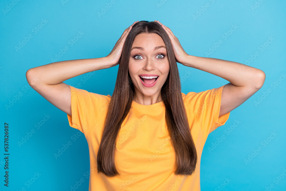 Closeup photo of young funny grimace reaction woman wear yellow t-shirt surprised good news touch head isolated on blue color background Closeup photo of young funny grimace reaction woman wear yellow t-shirt surprised good news touch head isolated on blue color background