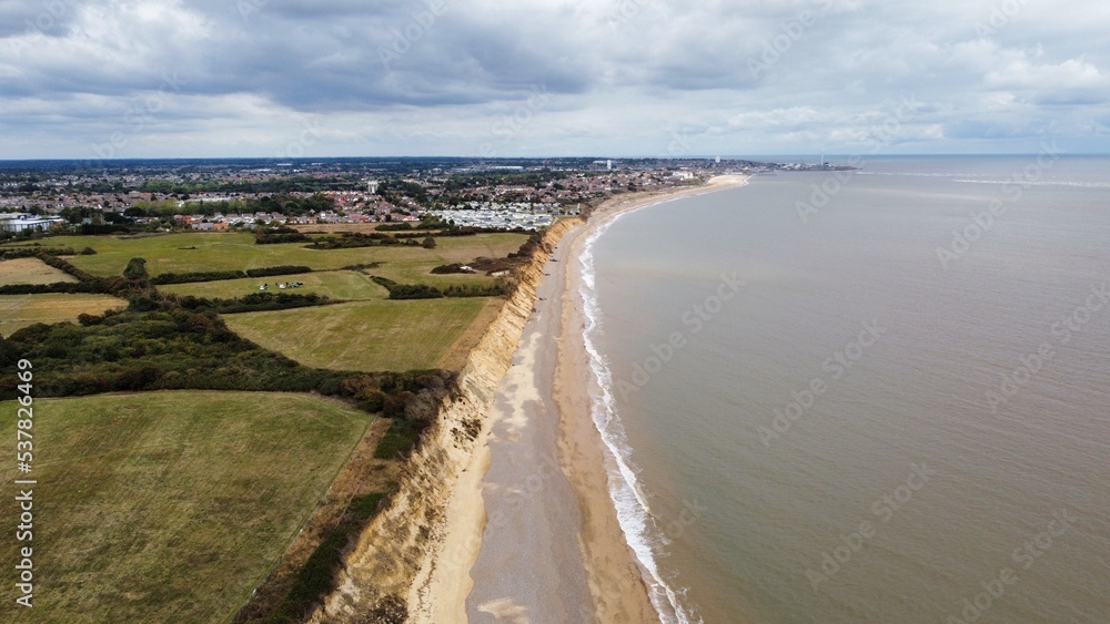 Aerial view of Lowestoft coast line with views of the beach and waves crashing. Suffolk coastal town. 