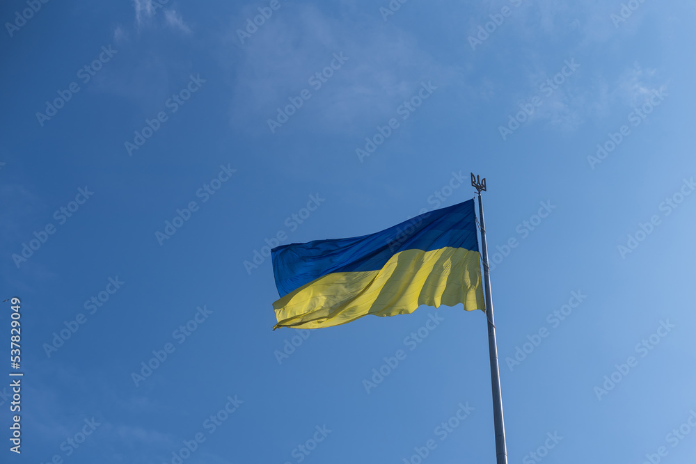 National flag of Ukraine against blue sky National flag of Ukraine against blue sky