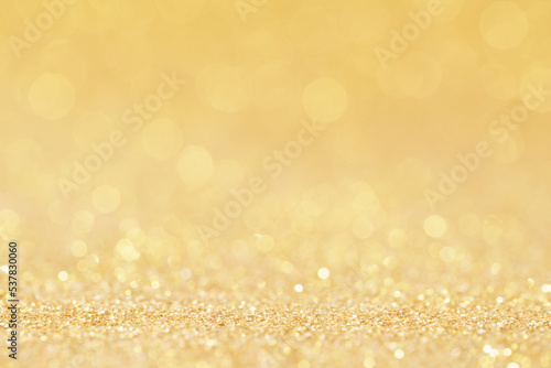 christmas golden glowlight glitter blur bokeh abstract  background.for holiday xmas and happy new year backdrop,luxury celebration wallpaper.