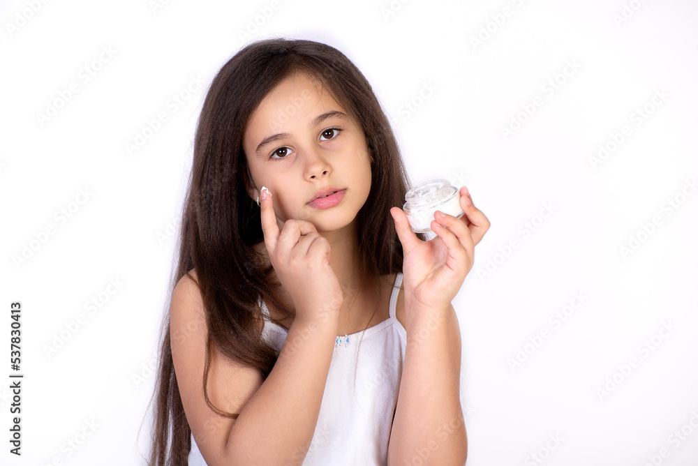 Happy child presenting beauty cosmetic product of facial skin cream Happy child presenting beauty cosmetic product of facial skin cream