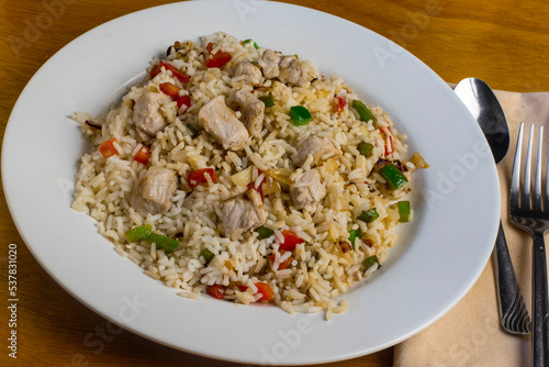 rice served with peppers onions and chicken